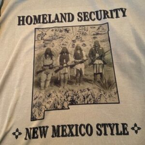 Homeland Security, New Mexico Style Beige T-Shirt with New Mexico State Outline and Indigenous Men With Rifles