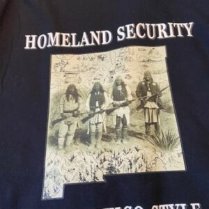 Homeland Security, New Mexico Style Black T-Shirt with New Mexico State Outline and Indigenous Men With Rifles